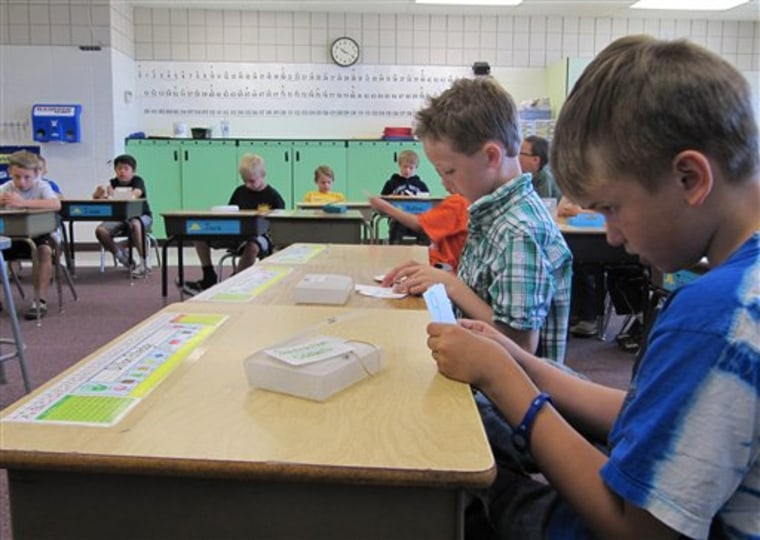 In this photo taken May 9, Dillon Elledge, 8, right, and Brody Kemble, 7, second from right, work with flash cards in their all-boys classroom at Middleton Heights Elementary in Middleton, Idaho. Middleton is believed to be the only public school in Idaho offering all-boy and all-girl classrooms, though the movement is widespread in other states.
